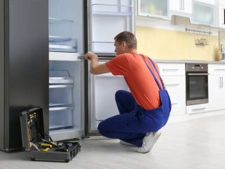 Technician is repairing single door fridge in Kolkata
